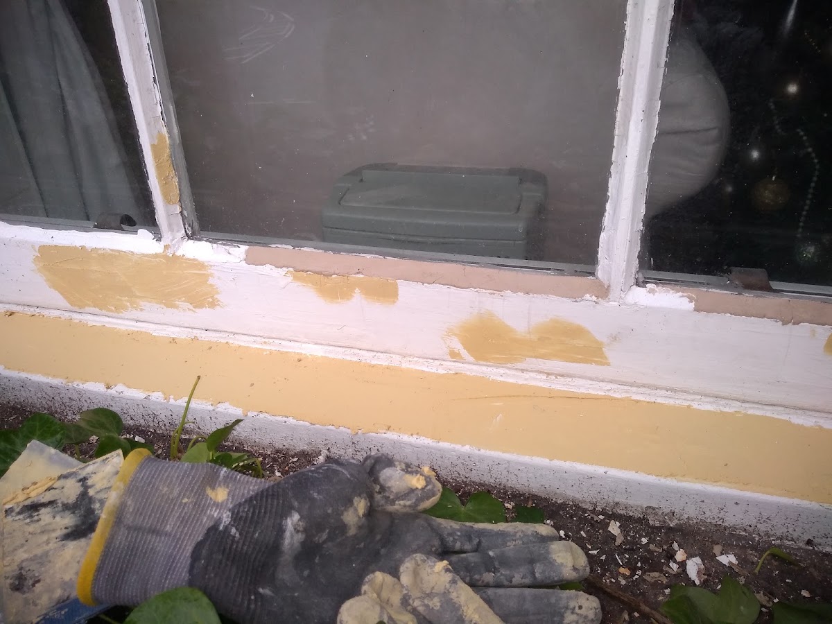 Filling and preparation work on a window frame before painting