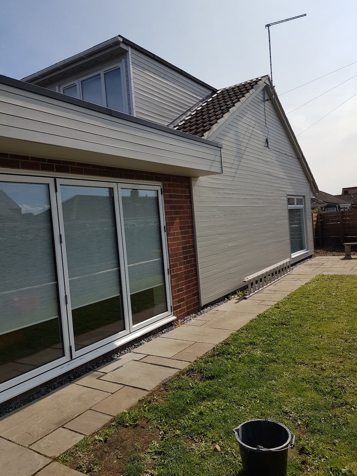 Exterior cladding and bi-fold doors in grey